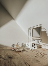 Elegant arrangement of perfumes and jewelry on a wooden table.