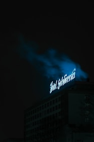 A dark-themed cityscape illuminated by neon lights representing IoT connectivity.