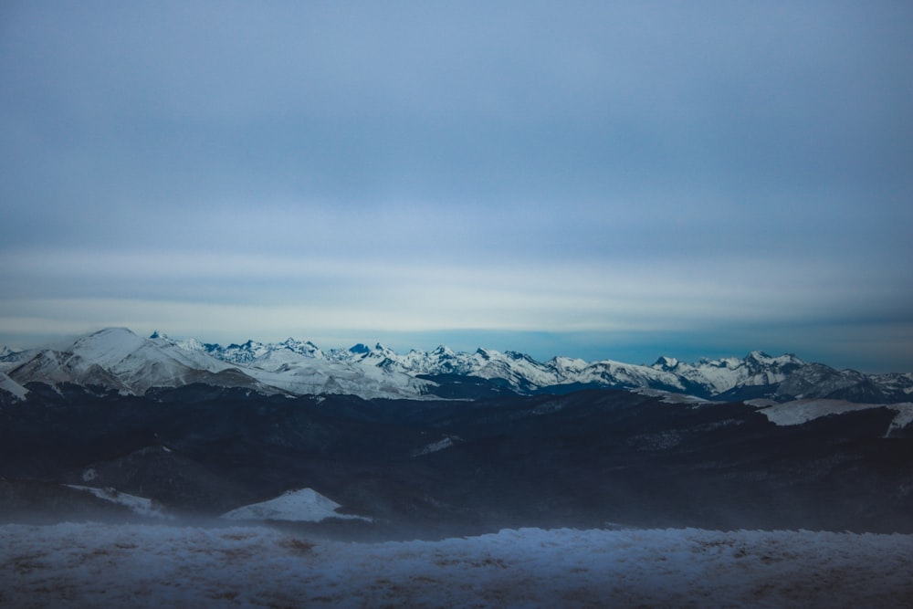 snow covered mountain under cloudy sky during daytime