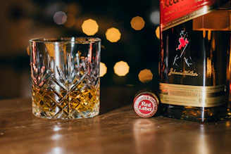 Bottles of Armenian cognac and whiskey glowing softly with a sleek gold-accented label design.