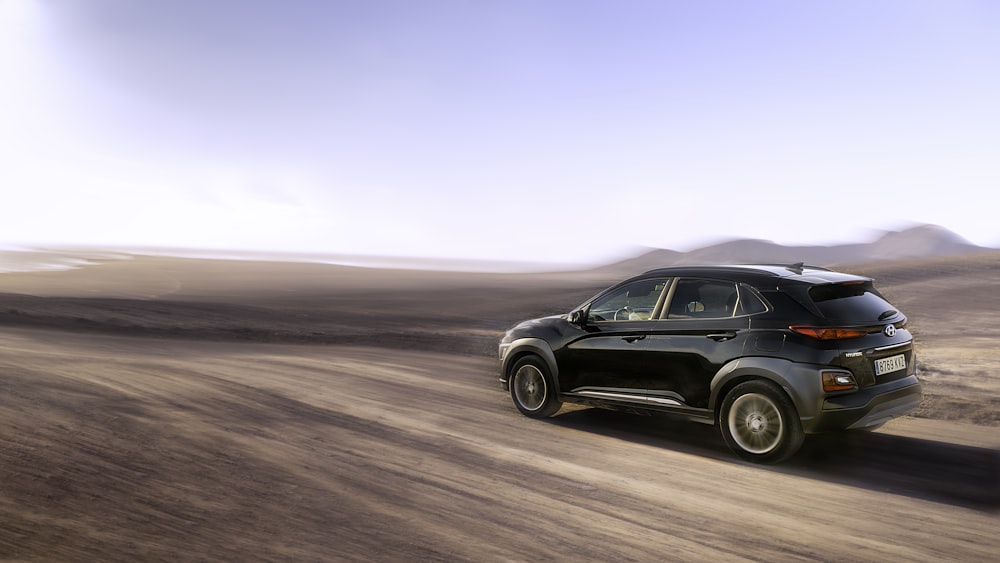 black suv on brown sand during daytime