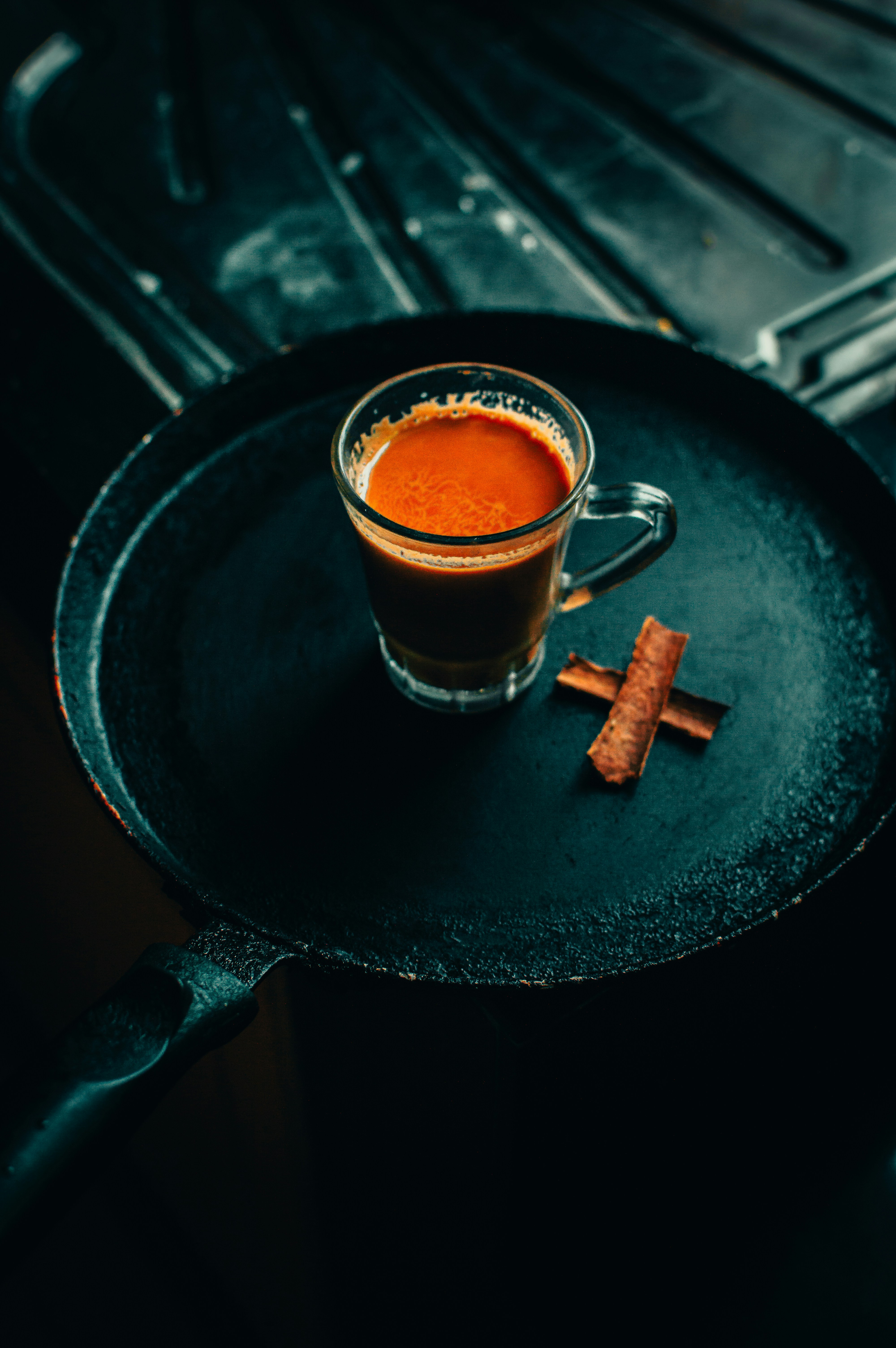 clear glass mug with brown liquid inside