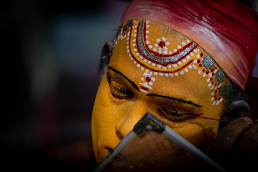 person with red and yellow face paint