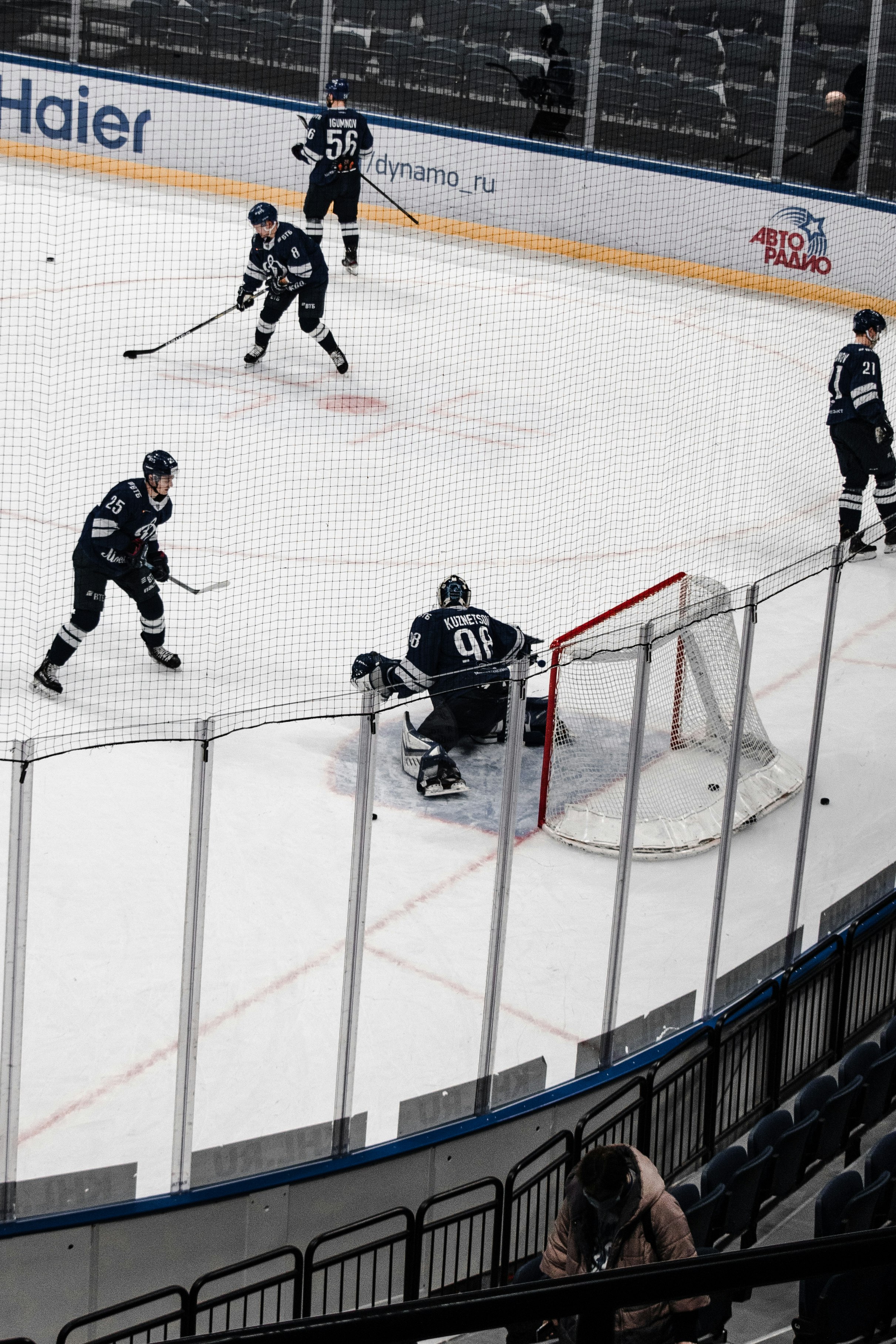 man in black ice hockey jersey riding on ice hockey stick