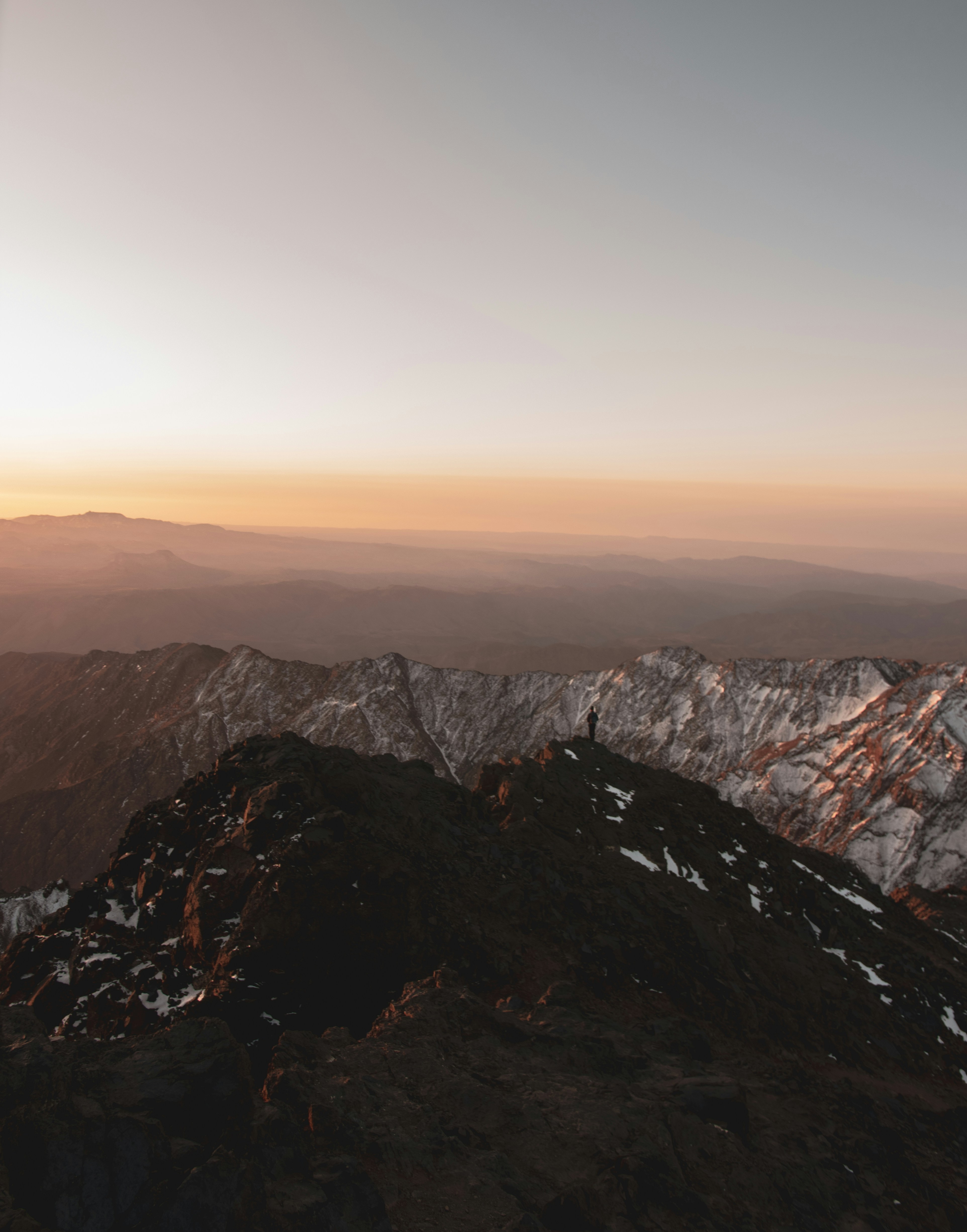brown and white mountains under white sky during daytime
