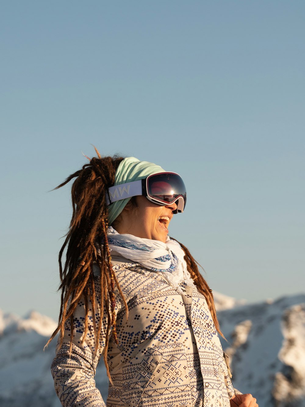 woman in white and black tribal print shirt wearing black sunglasses