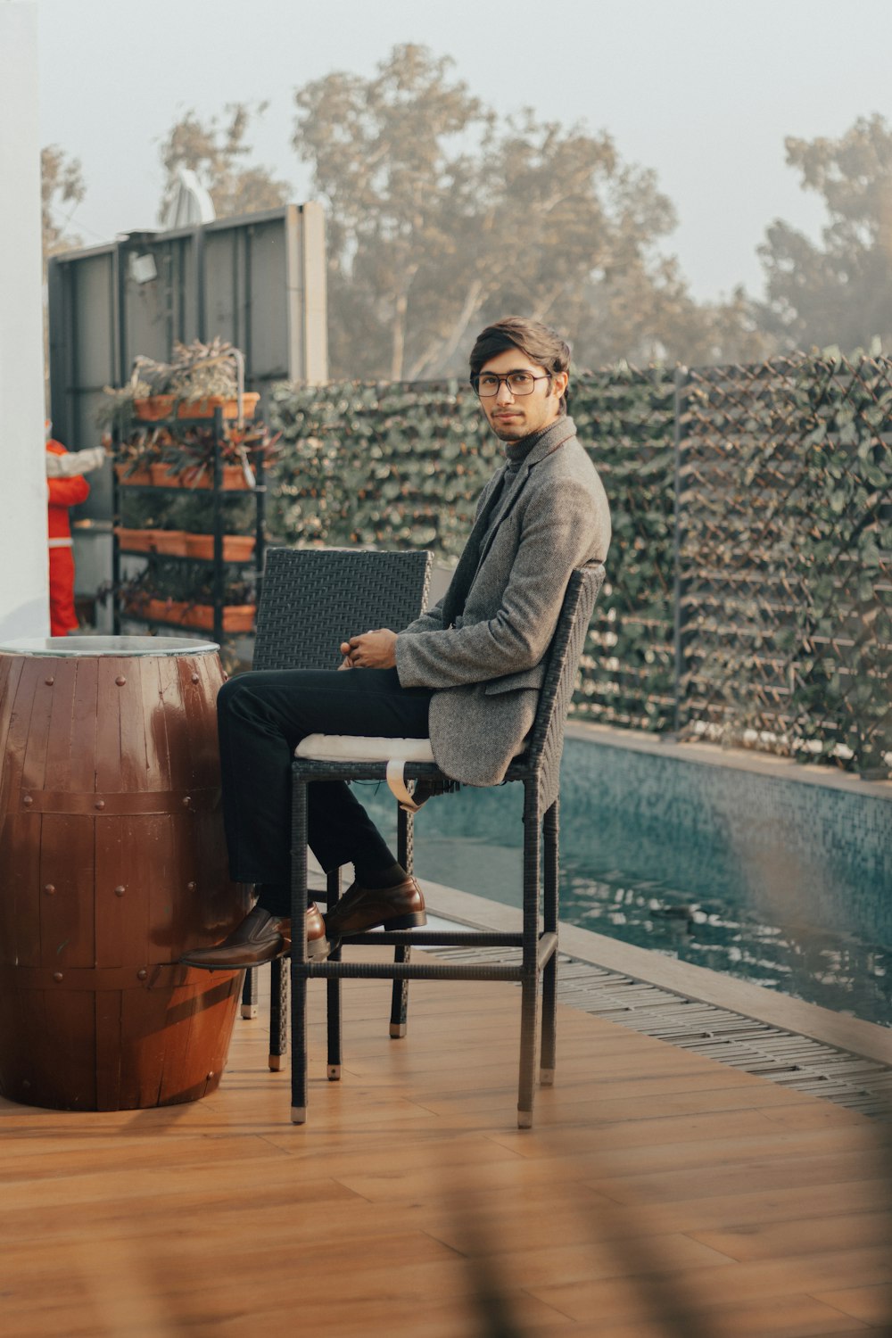 man in gray blazer sitting on black armchair