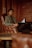 man in gray sweater sitting on brown leather armchair