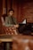 man in gray sweater sitting on brown leather armchair