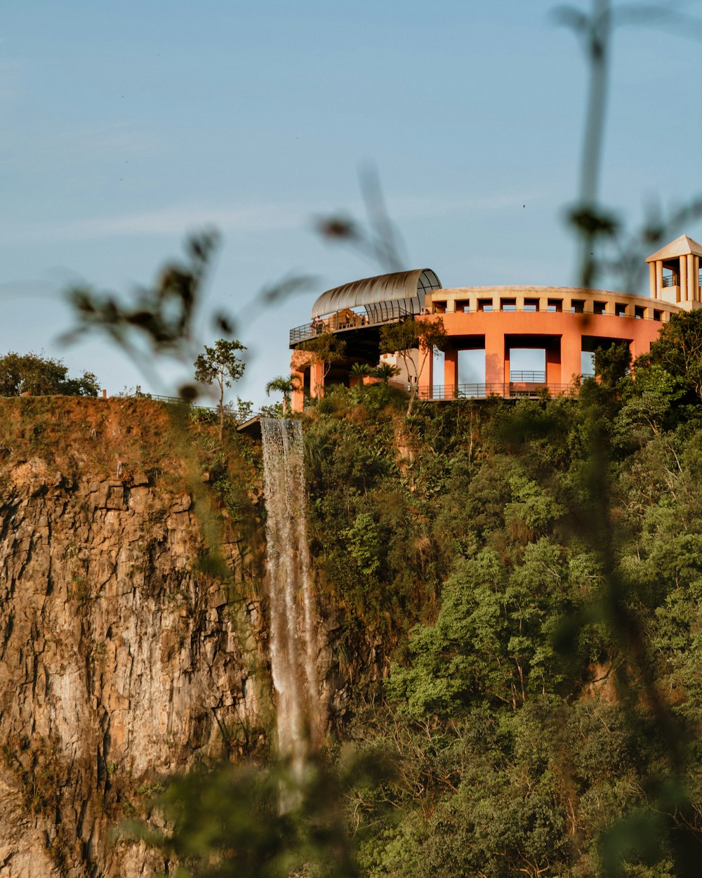 brown concrete building on top of hill