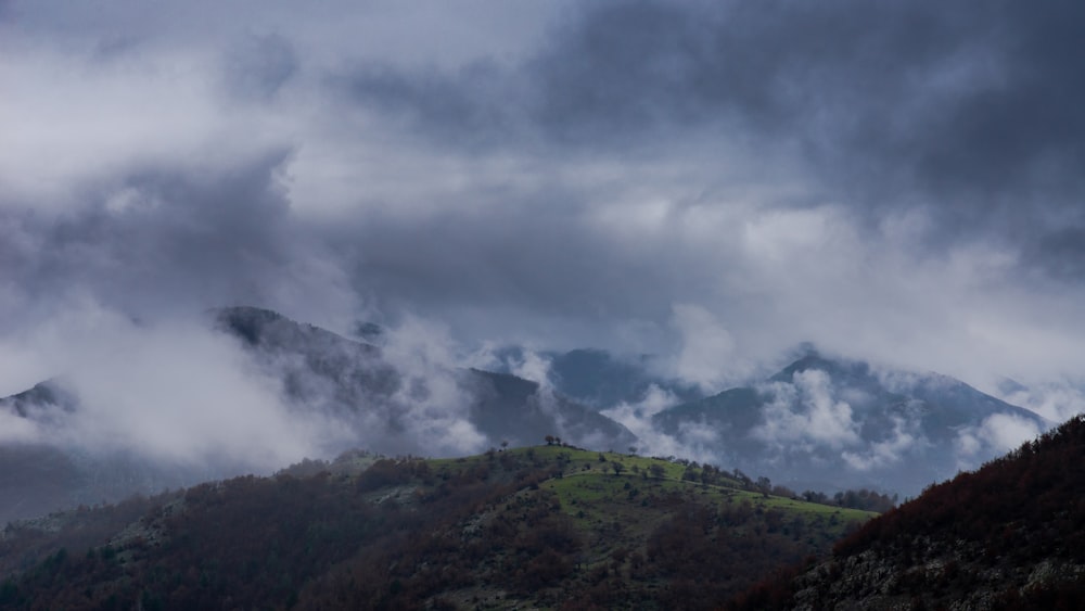 green mountain under white clouds