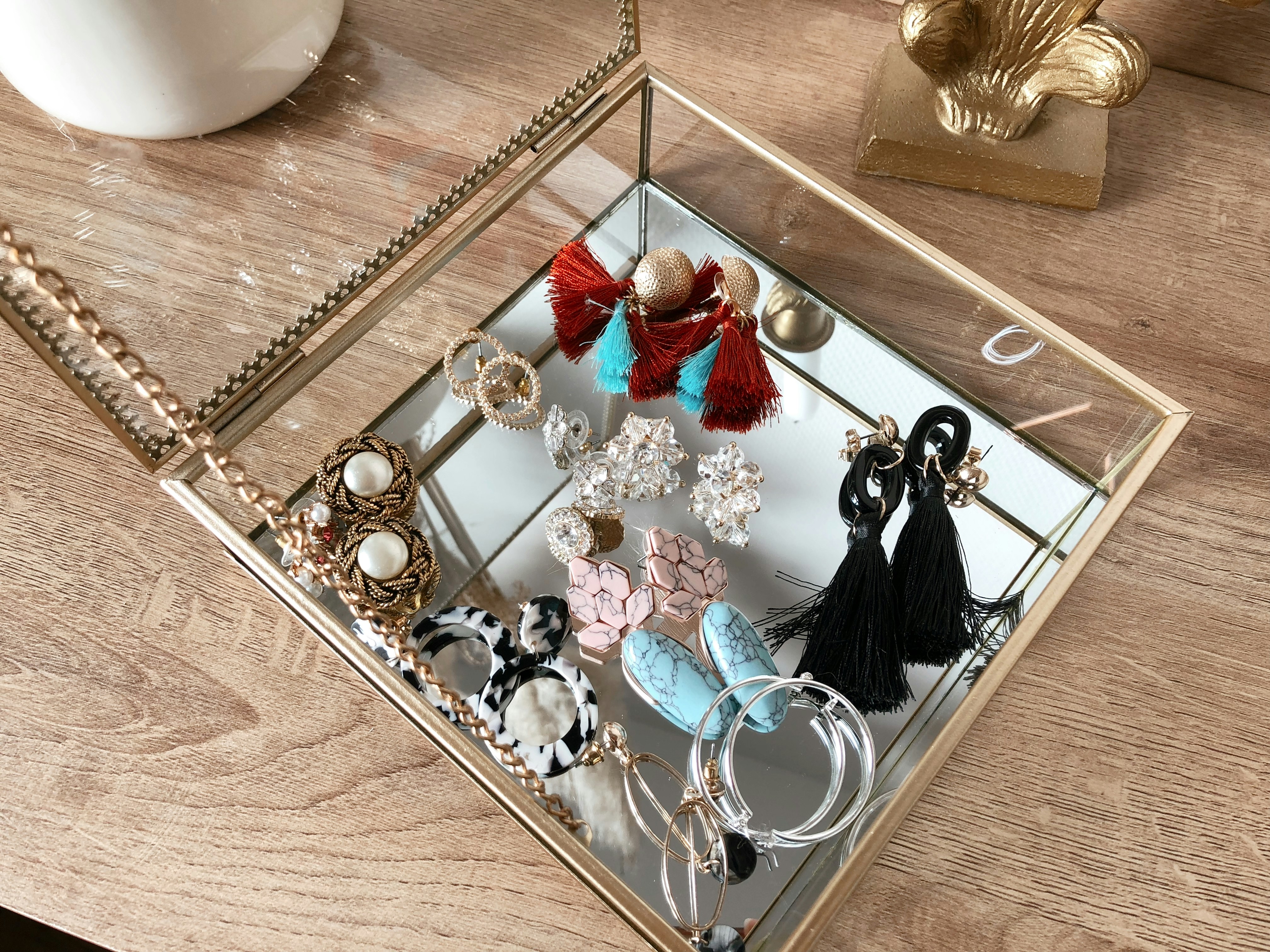 Dangling earrings in various colours arranged neatly