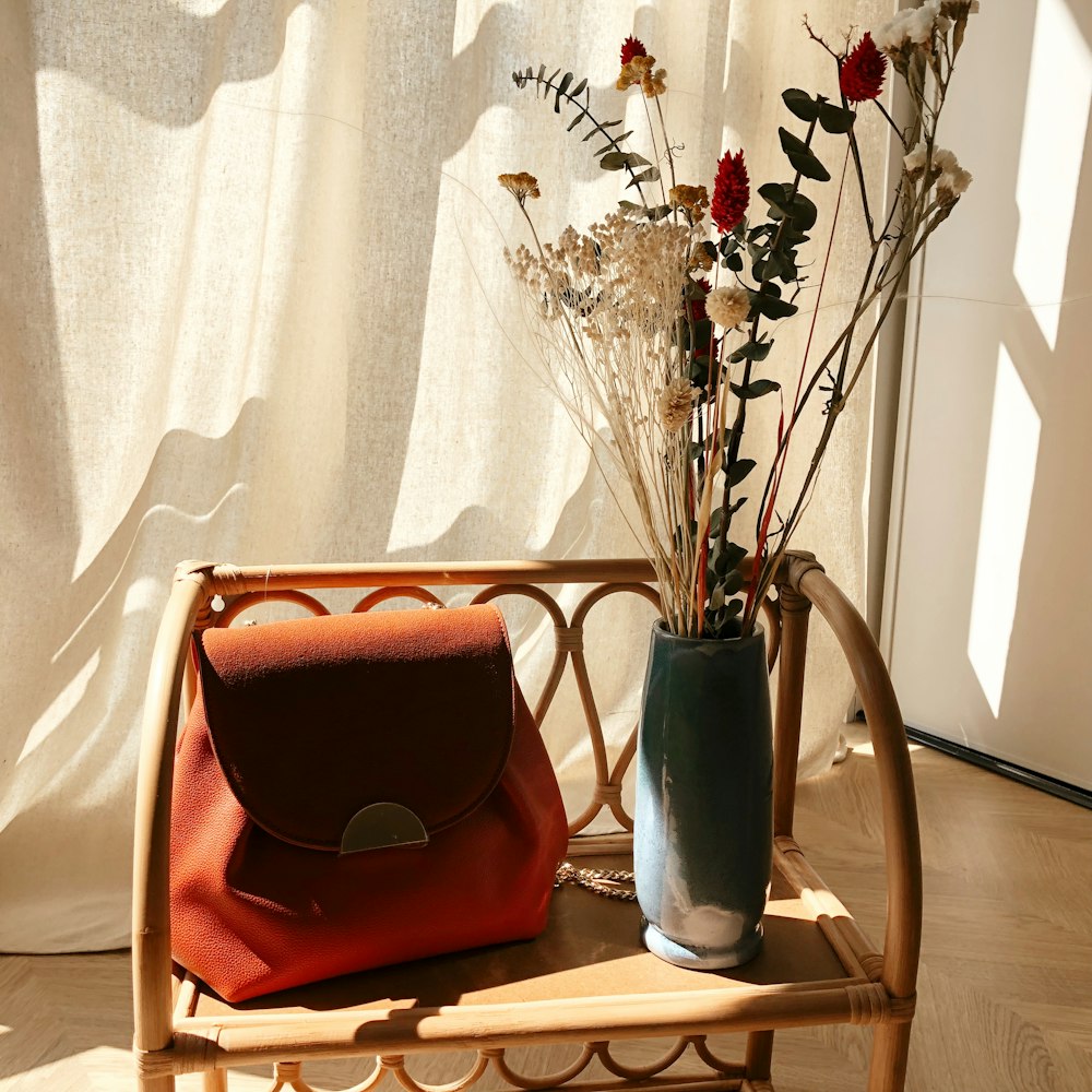 red and black leather bag on brown wooden table