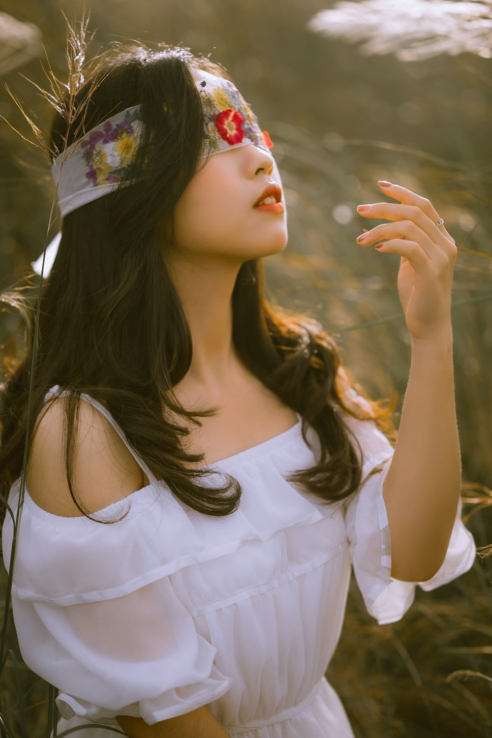 woman in white sleeveless dress with floral headband