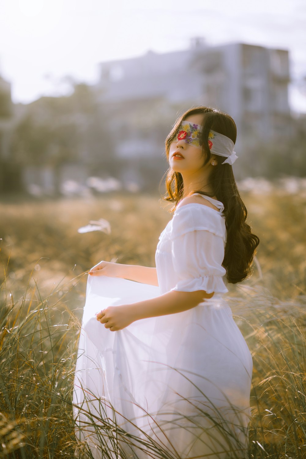 woman in white dress holding book