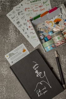 black pen beside white paper