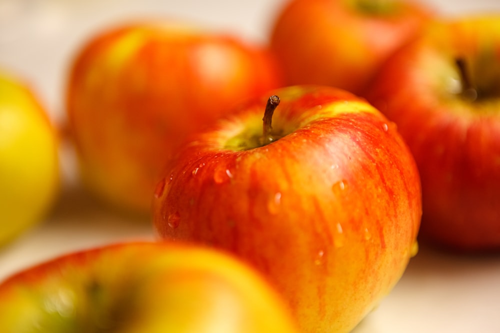 red apple fruit on white table