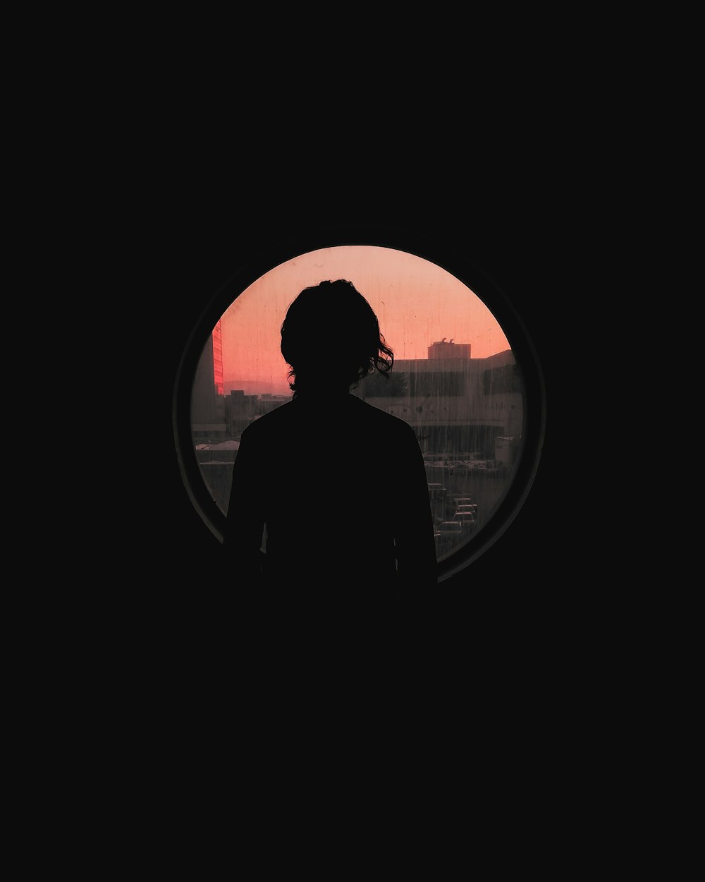 silhouette of man standing near window during daytime