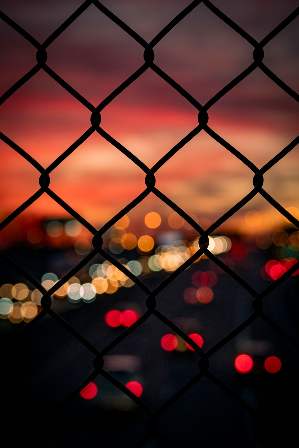 bokeh photography of chain link fence