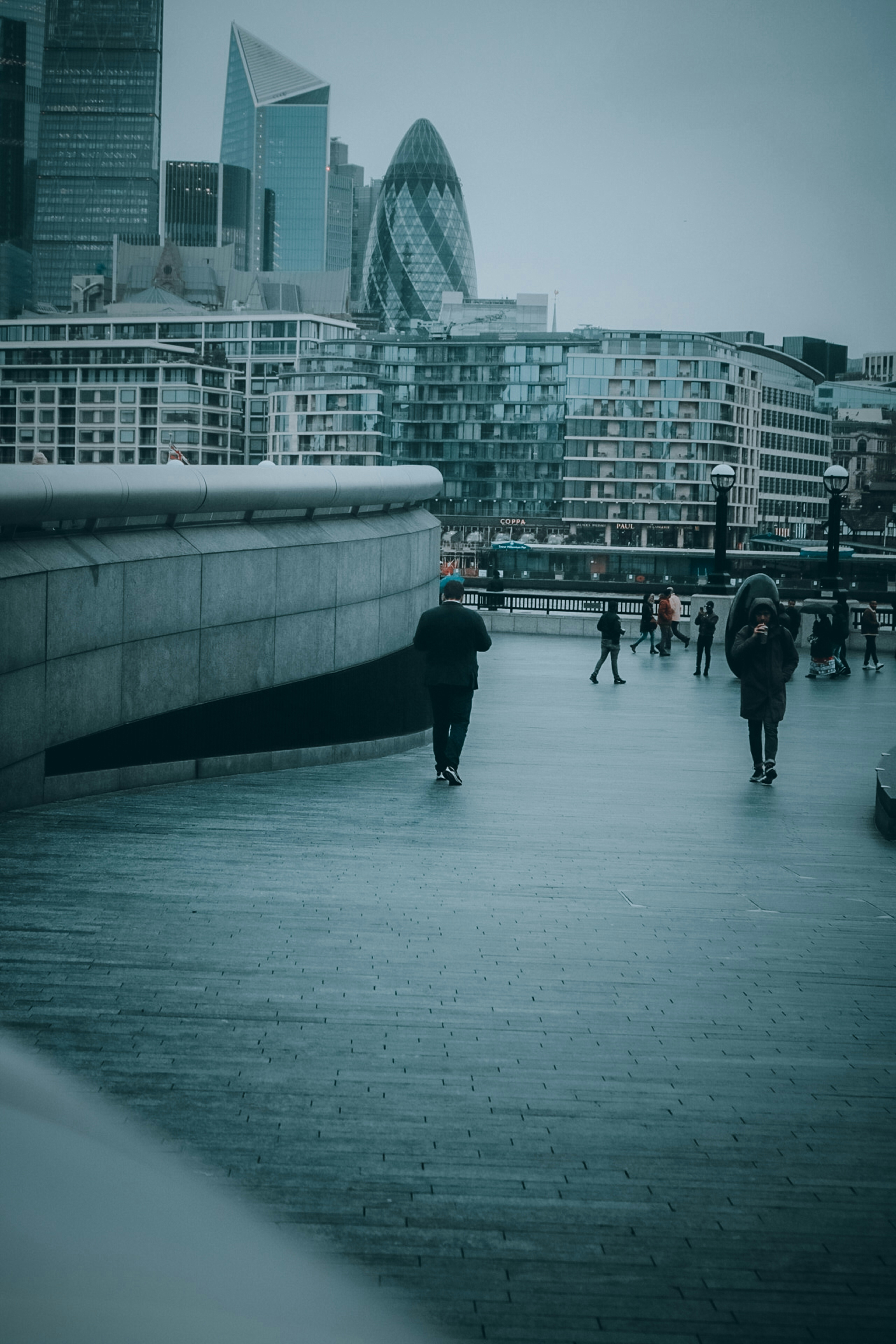 People walking on white concrete bridge during daytime