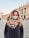 woman in black coat with scarf on her neck
