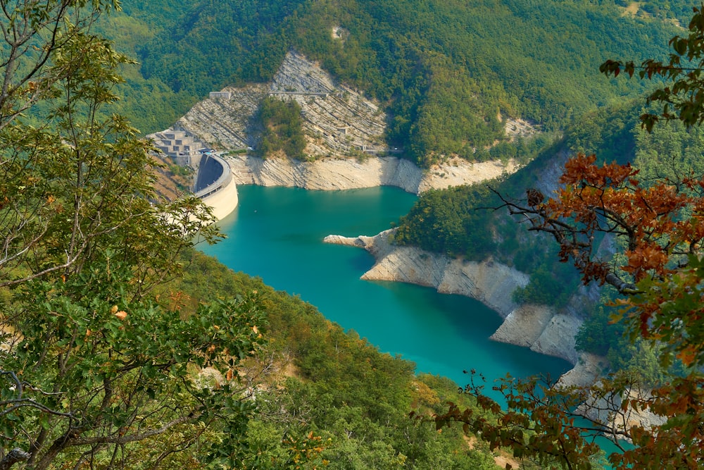 river in between green mountains during daytime