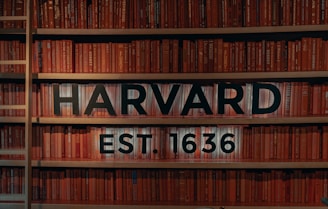 Bookshelf showcasing Harvard University established in 1636, symbolizing a tradition 
