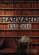a chair and table in front of a bookshelf