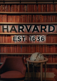 a chair and table in front of a bookshelf