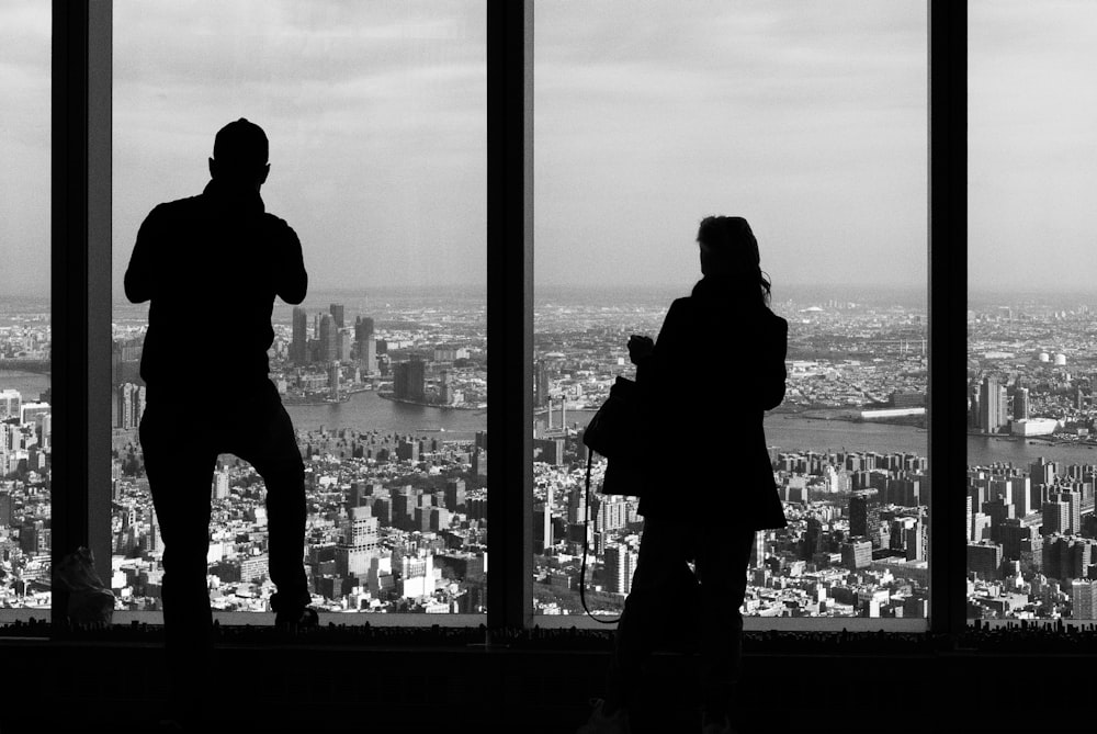 silhouette of man and woman standing on building during night time