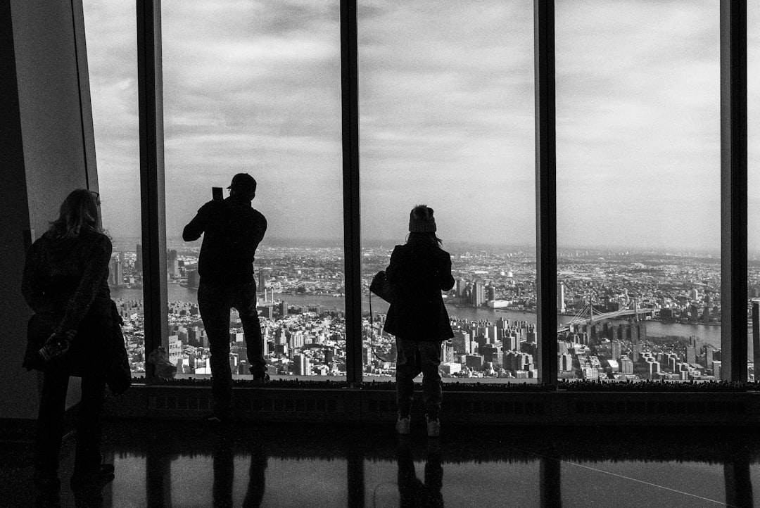 silhouette of 2 person standing on building