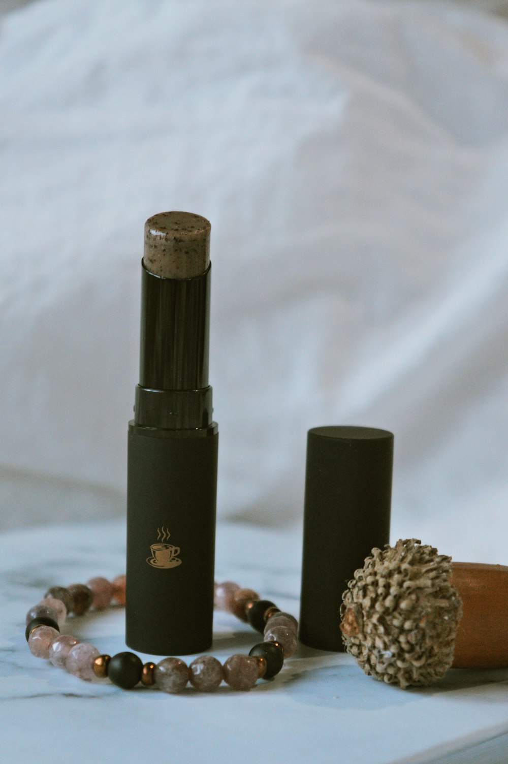 black and brown lipstick on white textile