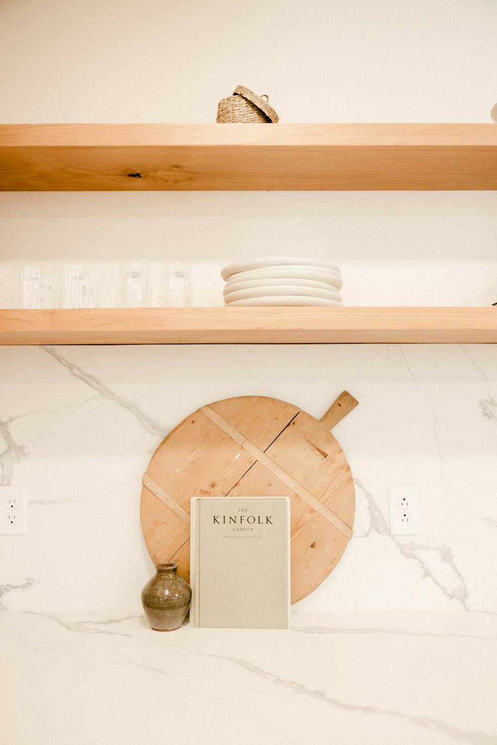 brown wooden round ornament on white wooden shelf