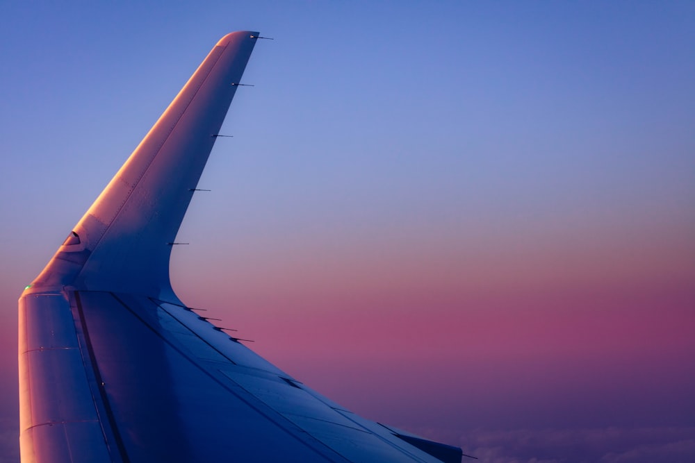 airplane wing under blue sky during daytime