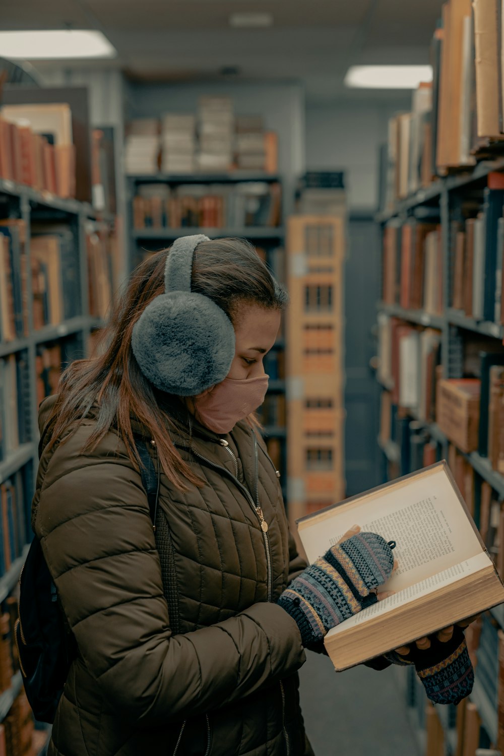 man in brown leather jacket reading book