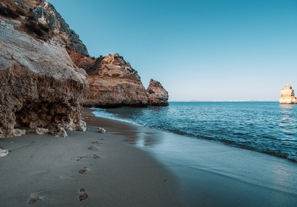 brown rock formation on sea shore during daytime