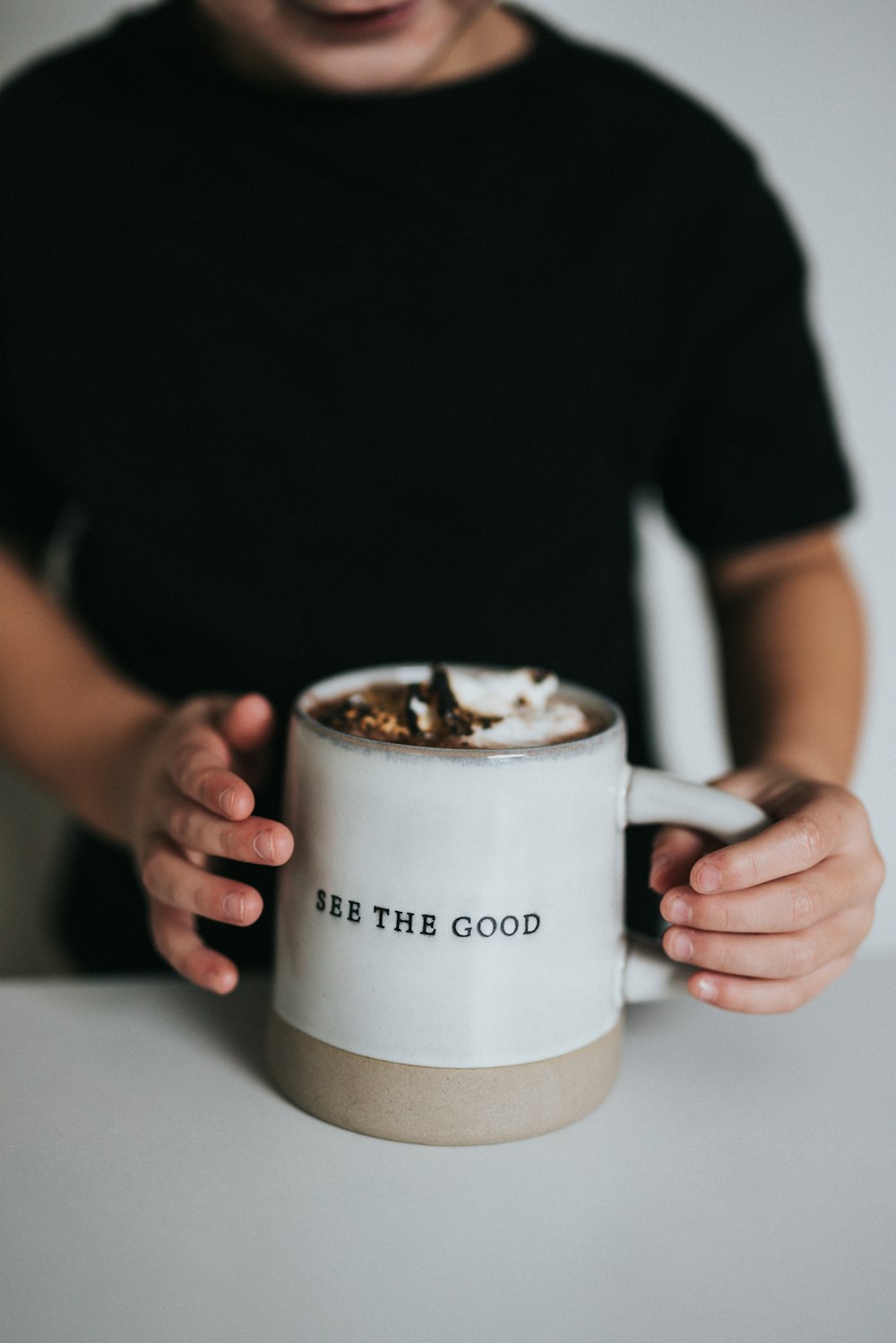 person holding white ceramic mug with coffee