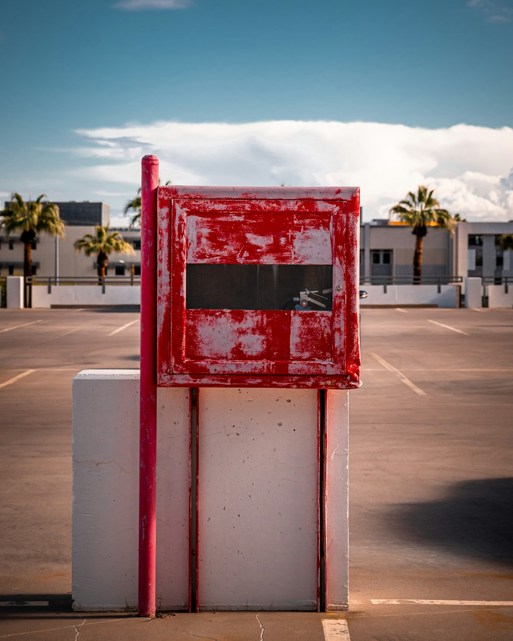red and white post near road