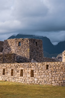 brown brick wall under cloudy sky during daytime