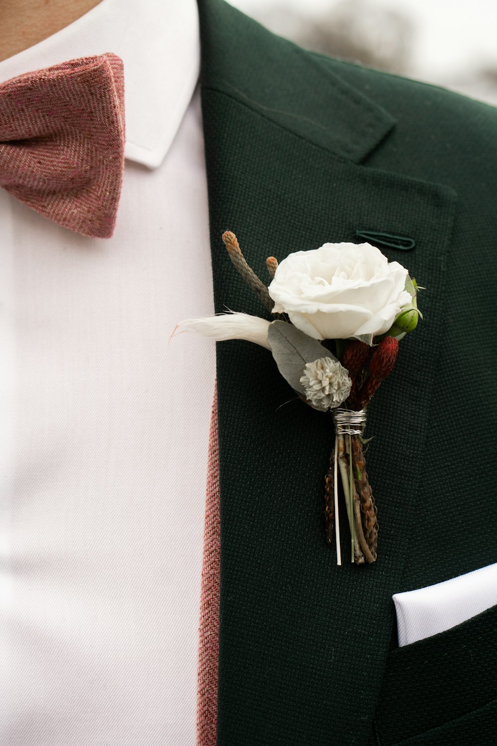 white rose on black suit jacket