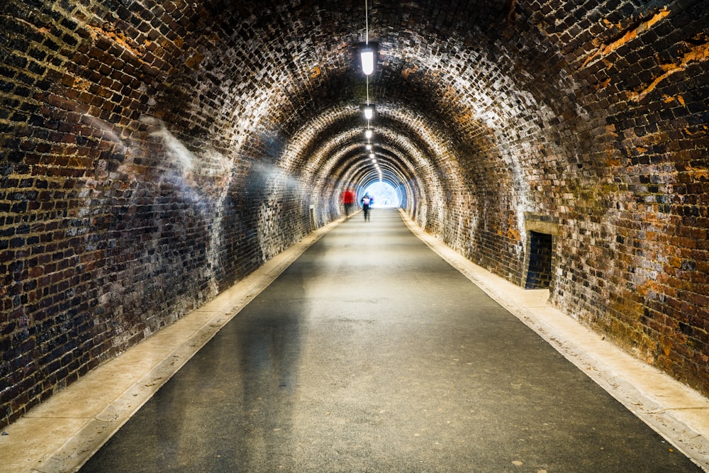 gray concrete tunnel with light