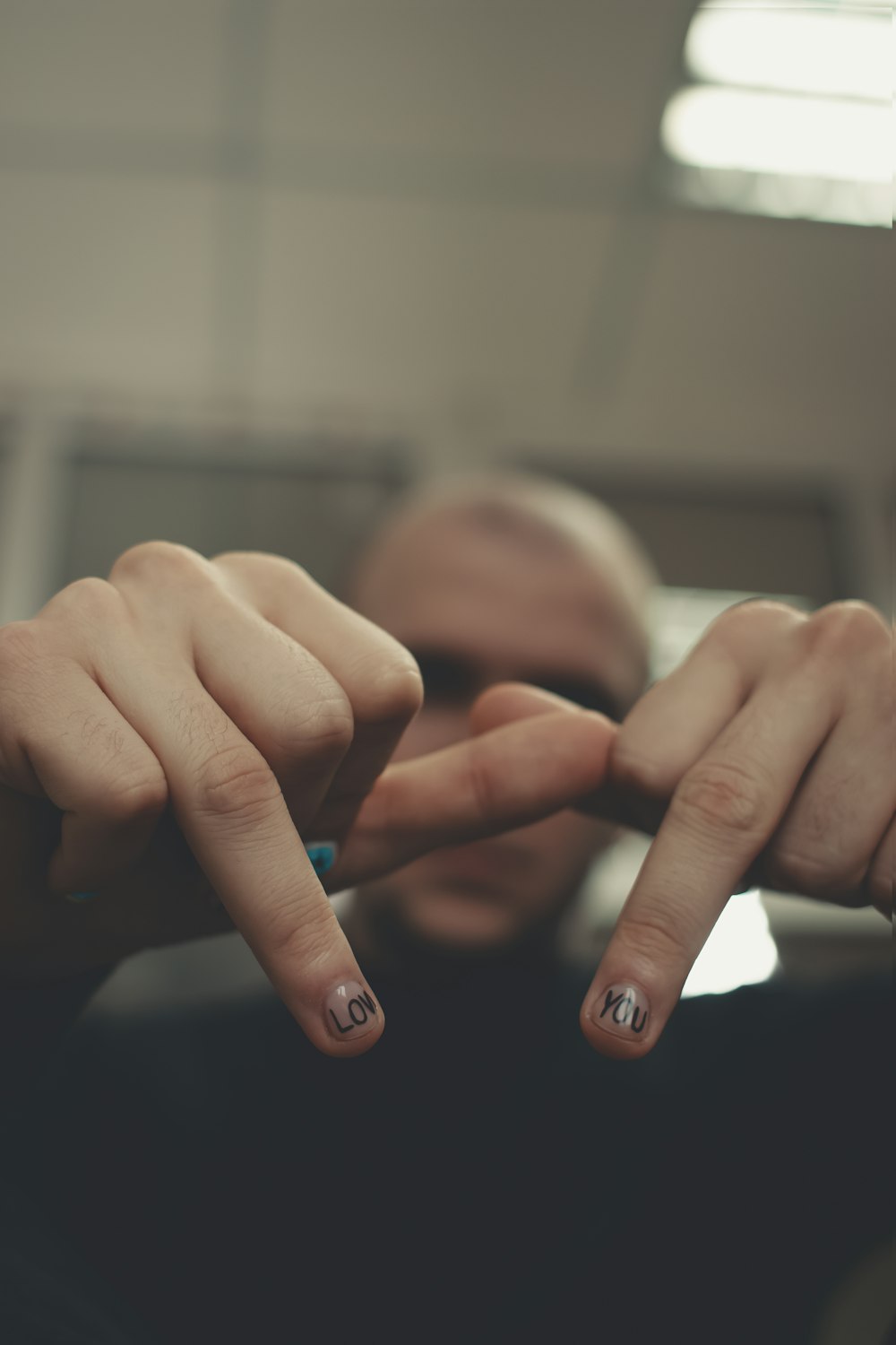 persons hand with blue manicure