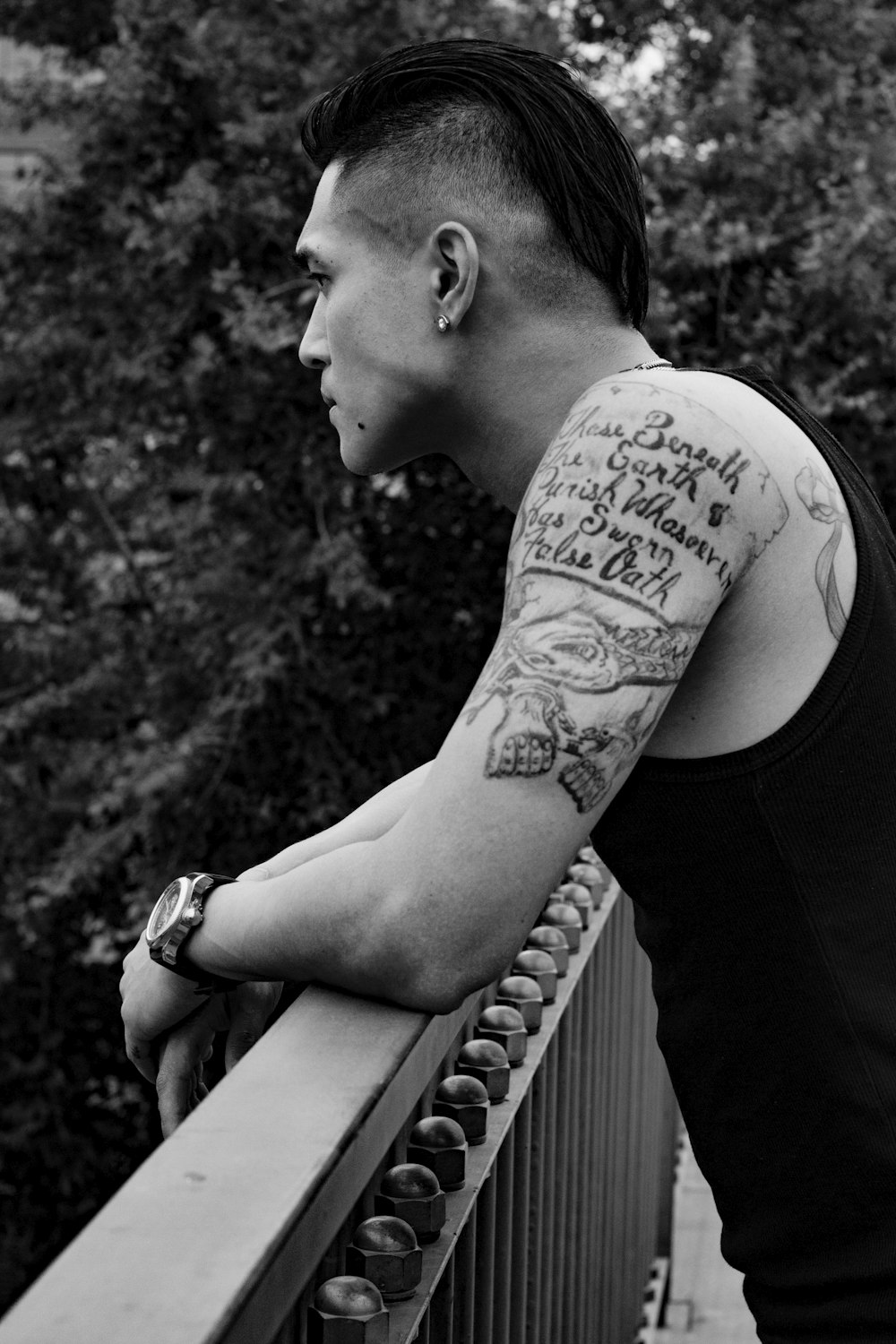 grayscale photo of man with tattoo on his back