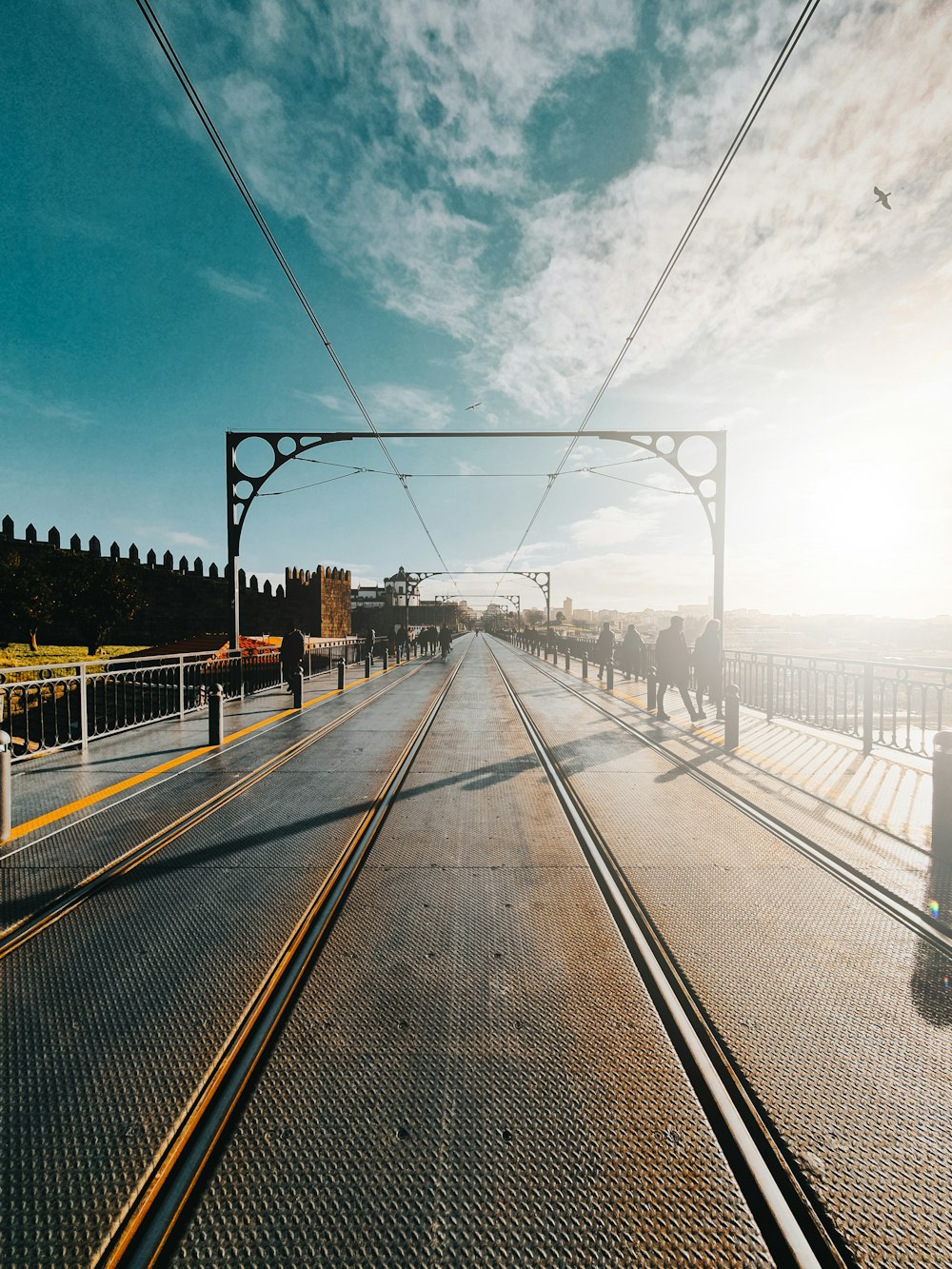 gray concrete road under blue sky during daytime