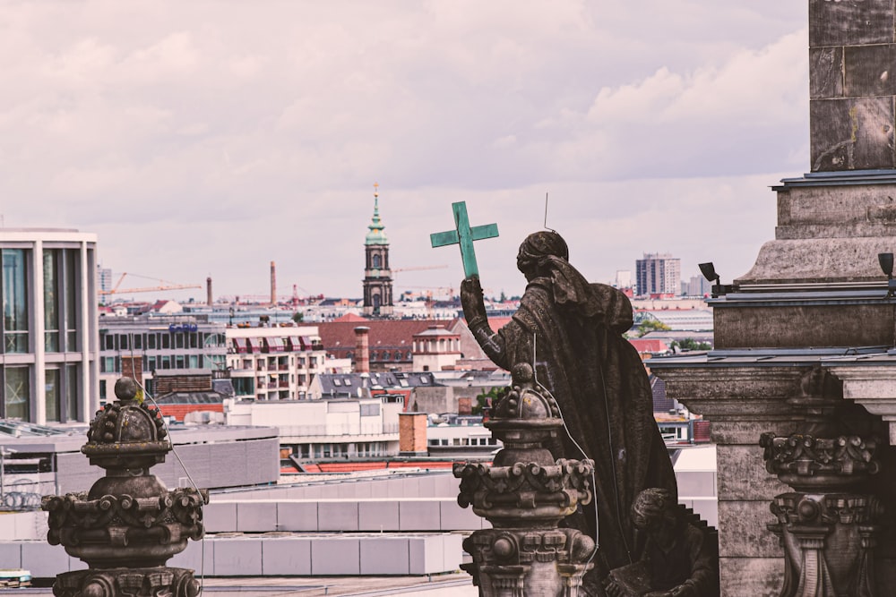 statue of man holding green flag