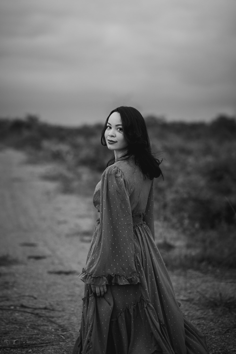 grayscale photo of woman in dress