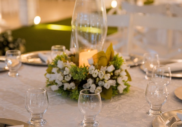 white flowers in clear glass vase on table