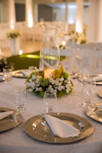 white flowers in clear glass vase on table