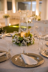 white flowers in clear glass vase on table