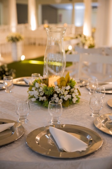 white flowers in clear glass vase on table